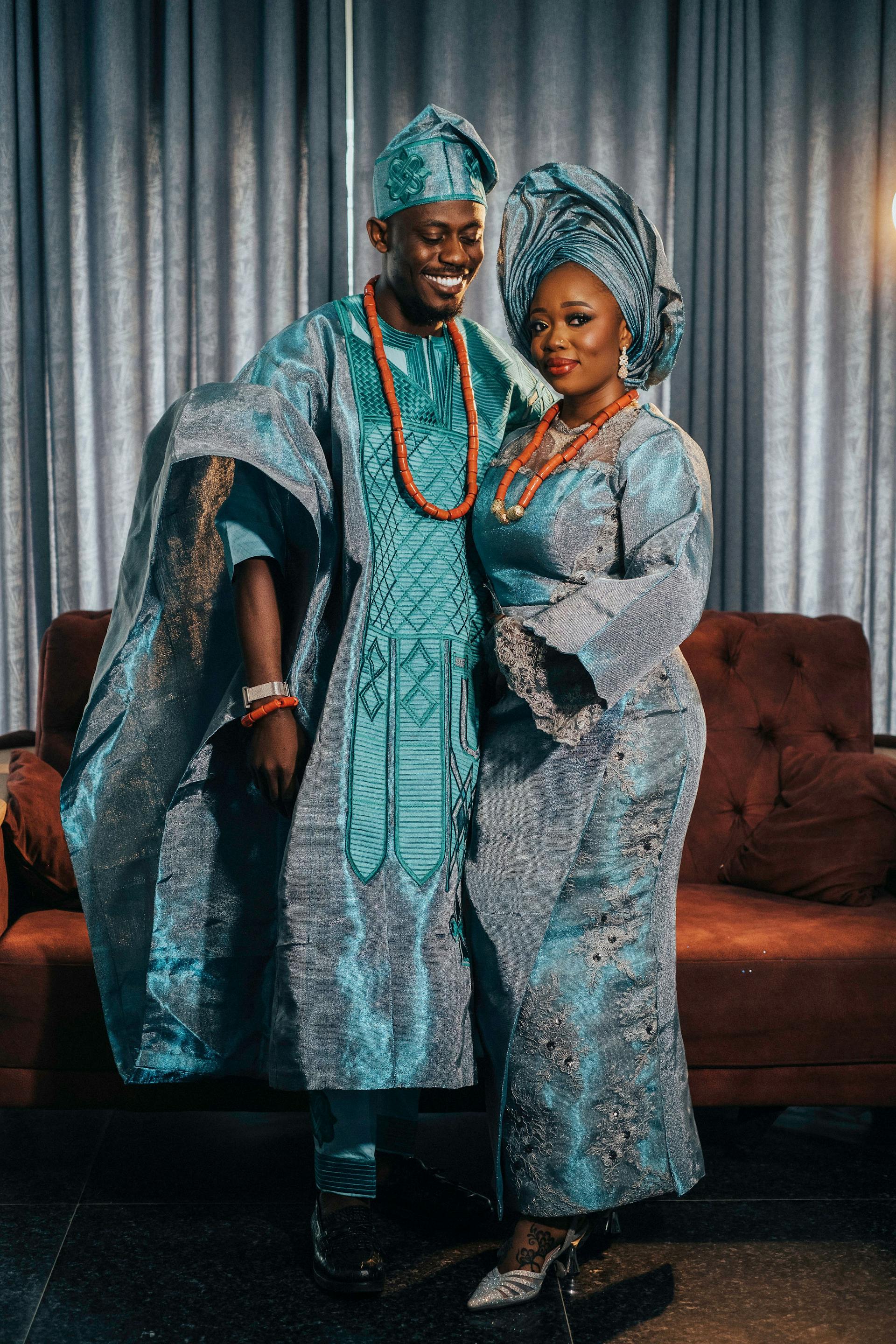 Woman in vibrant red Ankara dress outside Glorious Fashion boutique, Peckham